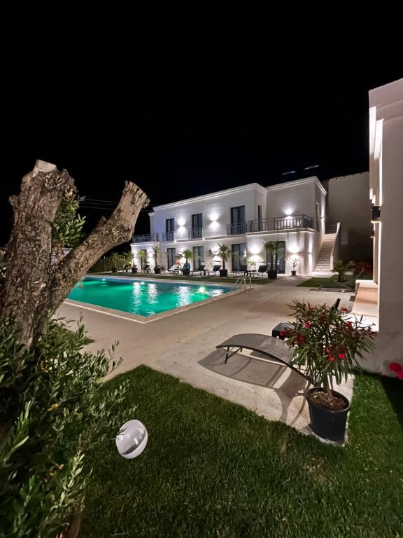 a villa with a swimming pool at night at Villa Gyos in Costinesti