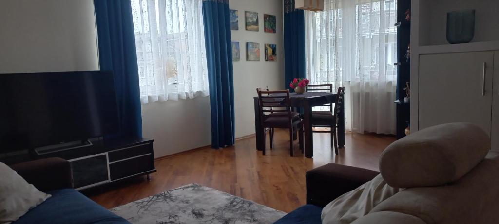 a living room with a table and a dining room at Apartament Na Wydmie in Ustka
