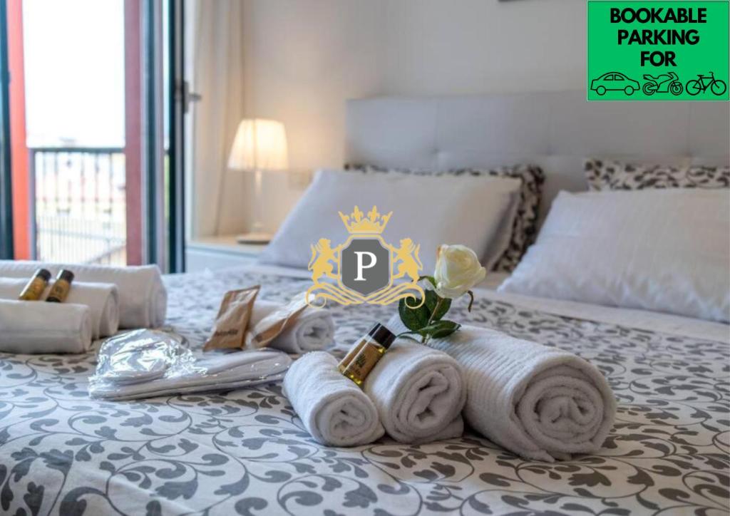 a bedroom with a bed with towels on it at Charme in Porta Palio - City Center in Verona