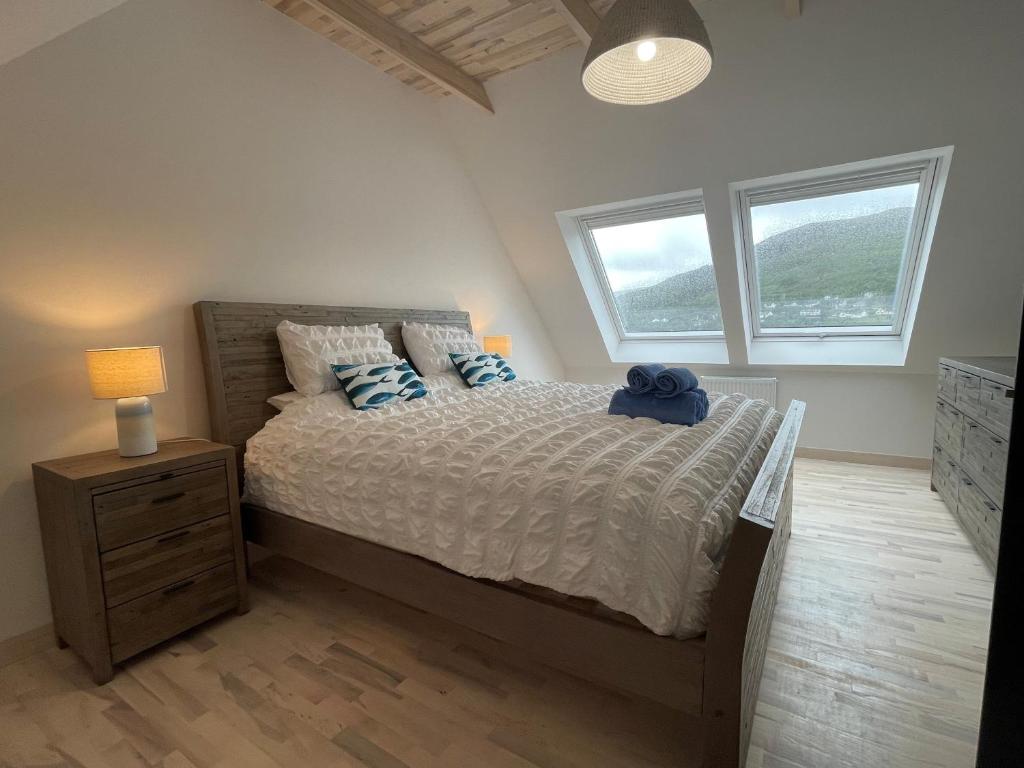 En eller flere senge i et værelse på Fisherman's Cottage