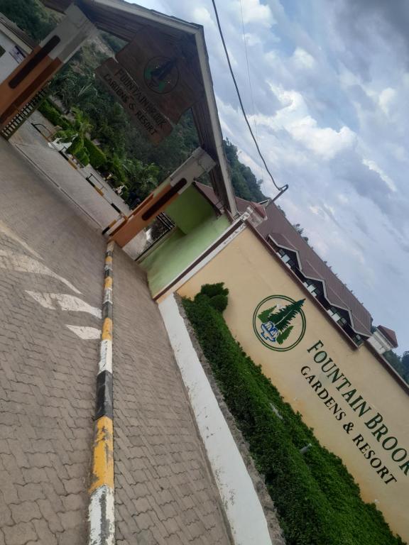 a building with a sign on the side of it at Fountain Brook Gardens & Resort in Thika