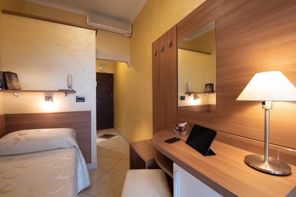 Postel nebo postele na pokoji v ubytování Hotel Petronio