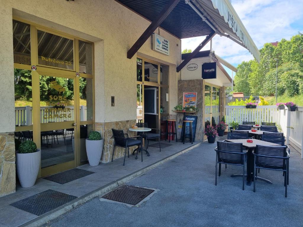 a restaurant with tables and chairs outside of it at Guesthouse Koprivec in Ljubljana