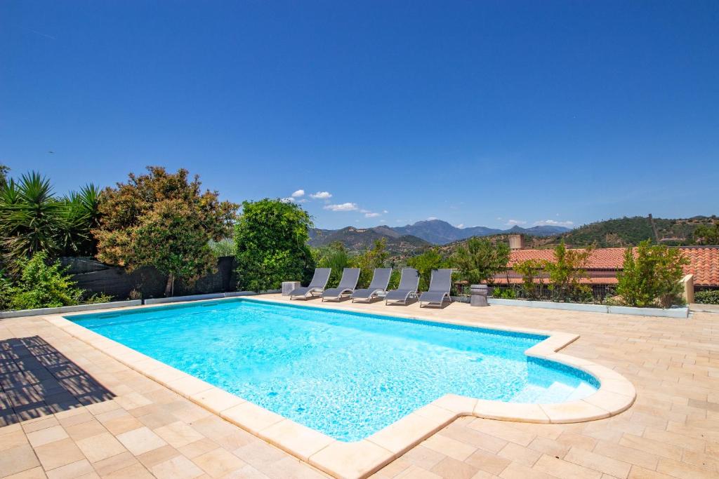 a swimming pool with lounge chairs and a swimming pool at Villetta Is Carcuris in Cardedu
