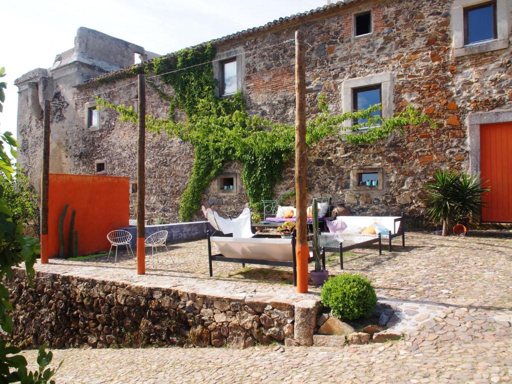 a stone house with a patio in front of it at Convento Senhora da Vitória in Castelo de Vide