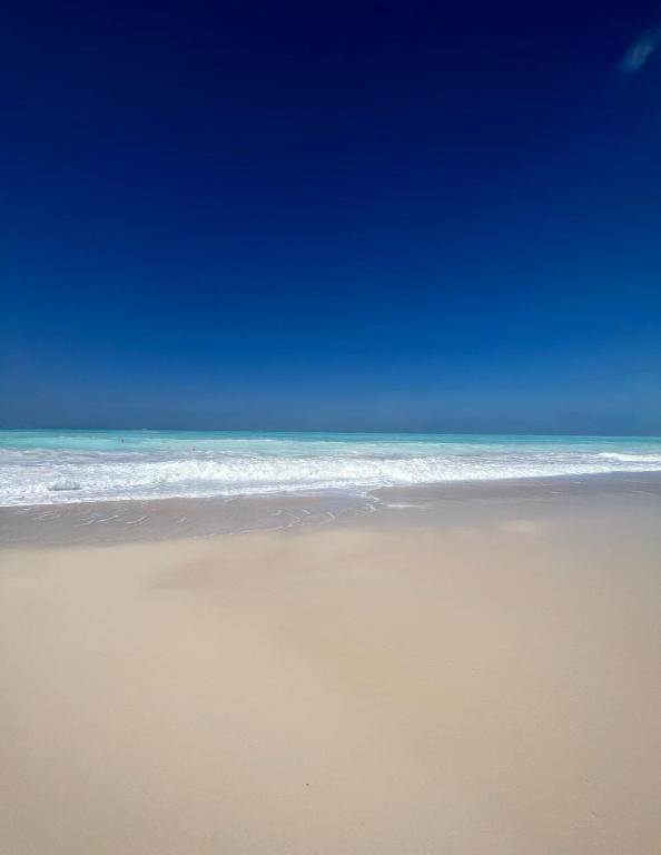 a beach with a blue sky and the ocean at Marassi El Alamein Luxury Villa مراسي العلمين in El Alamein