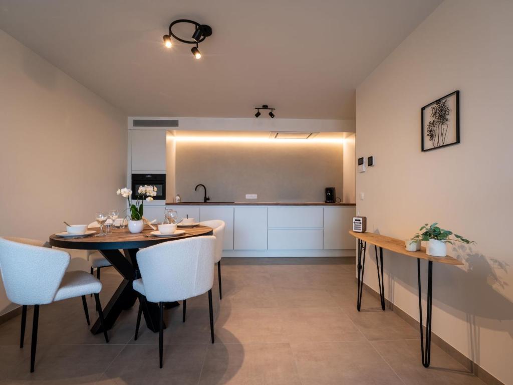 a kitchen and dining room with a table and chairs at Apartment Elyana with balcony by Interhome in Blankenberge
