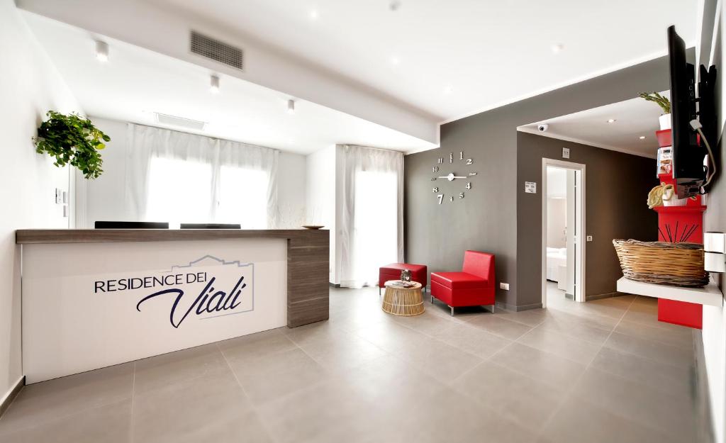 a lobby with a restaurant hall with a red chair at Residence Dei Viali in Ragusa