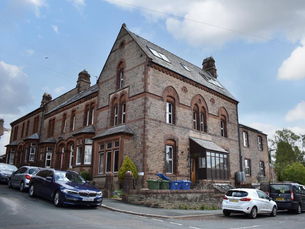 a large brick building with cars parked in front of it at Inglewood Terrace in Penrith