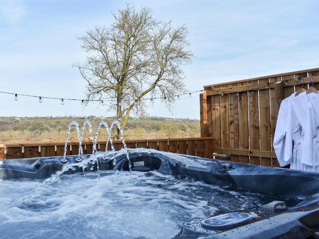 a hot tub with water coming out of it at Old Stables Cottage in Hunwick