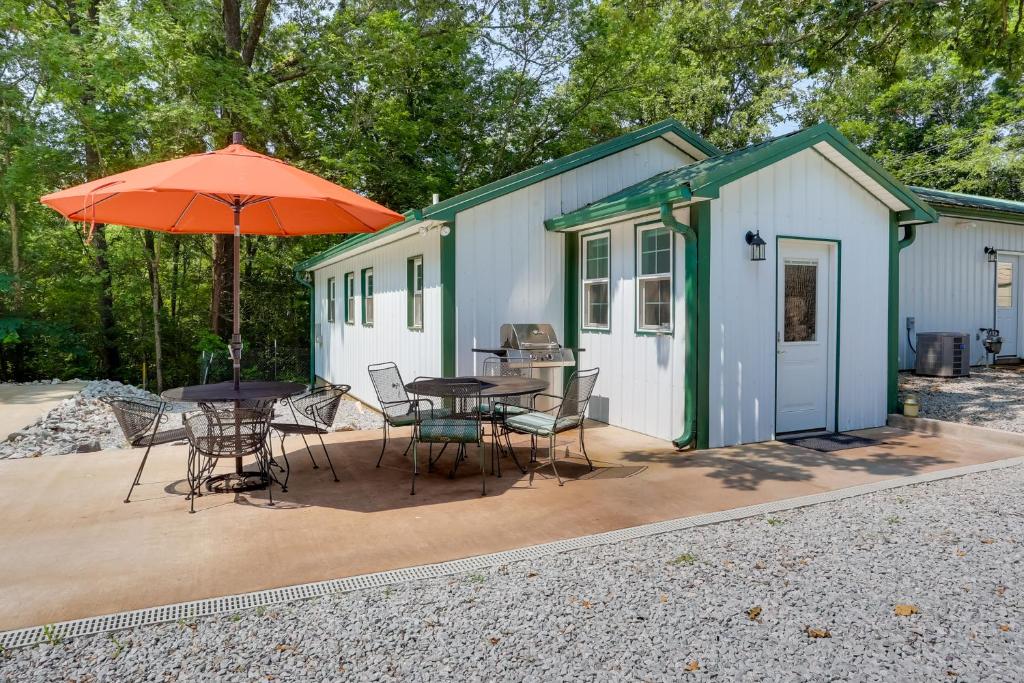 a house with a table and chairs and an umbrella at Shared Boat Ramp at Kentucky Lake Retreat in New Johnsonville