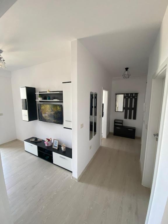 a white living room with a fish tank on the wall at Suba's Apartment Free Parking Self Check-in in Timişoara