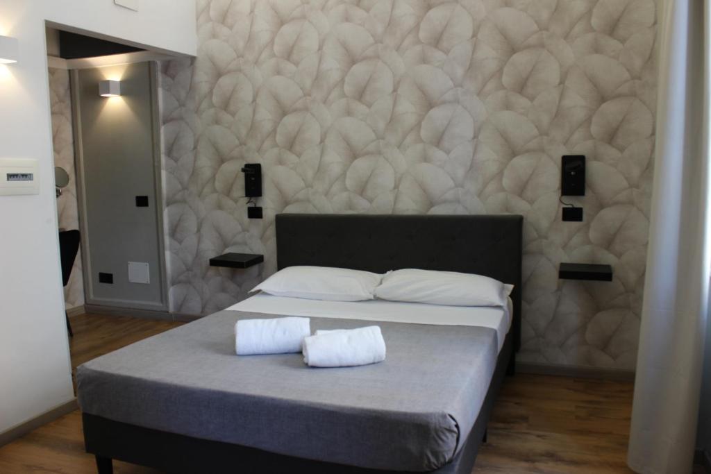 a bedroom with a bed with two pillows on it at Rooms Piramide 1 in Rome