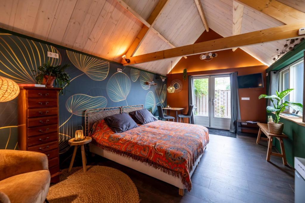 a bedroom with a bed in a room at B&B de Gouwe Tijd, suite Het Gouden Blad in Noordgouwe