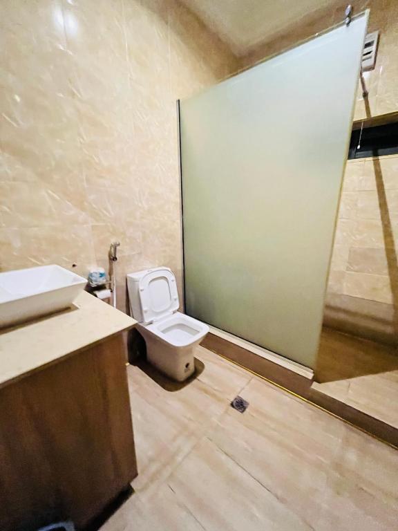 a bathroom with a toilet and a sink at Global Suites in Kano