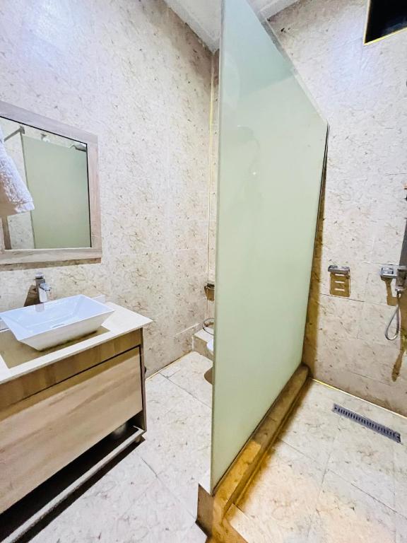 a bathroom with a sink and a mirror at Global Suites in Kano