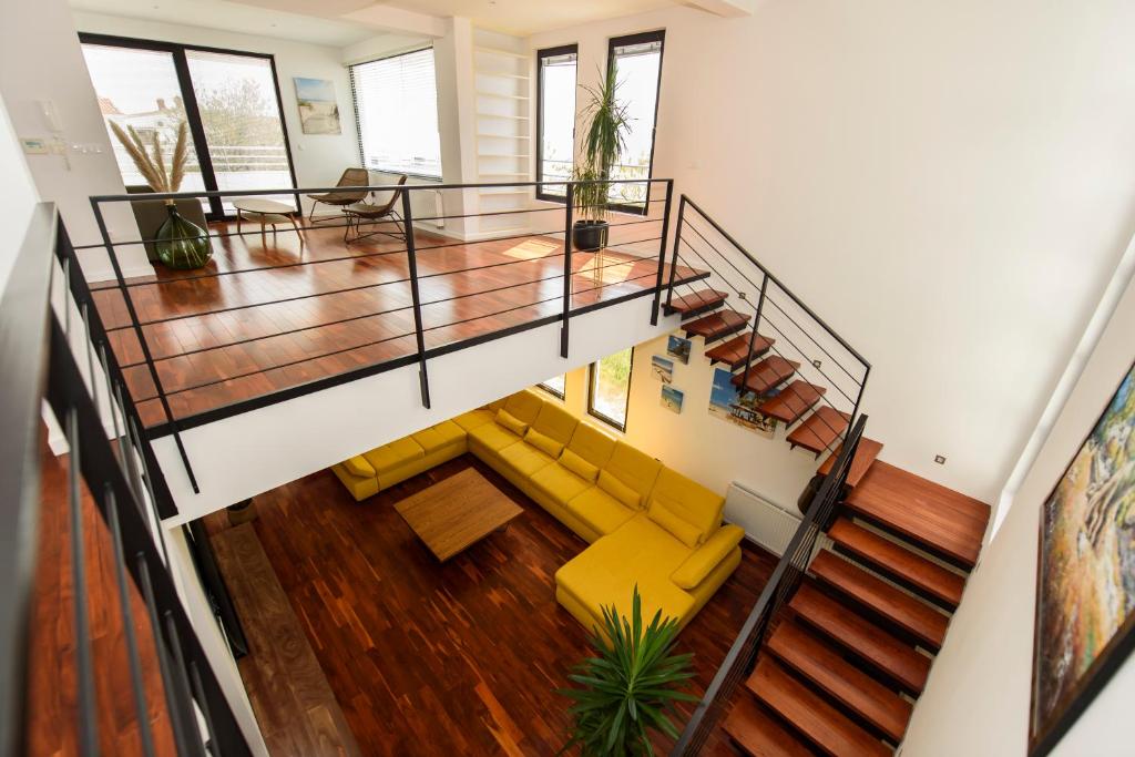 an overhead view of a living room with stairs and yellow chairs at Villa Simon2 in Veliko Brdo