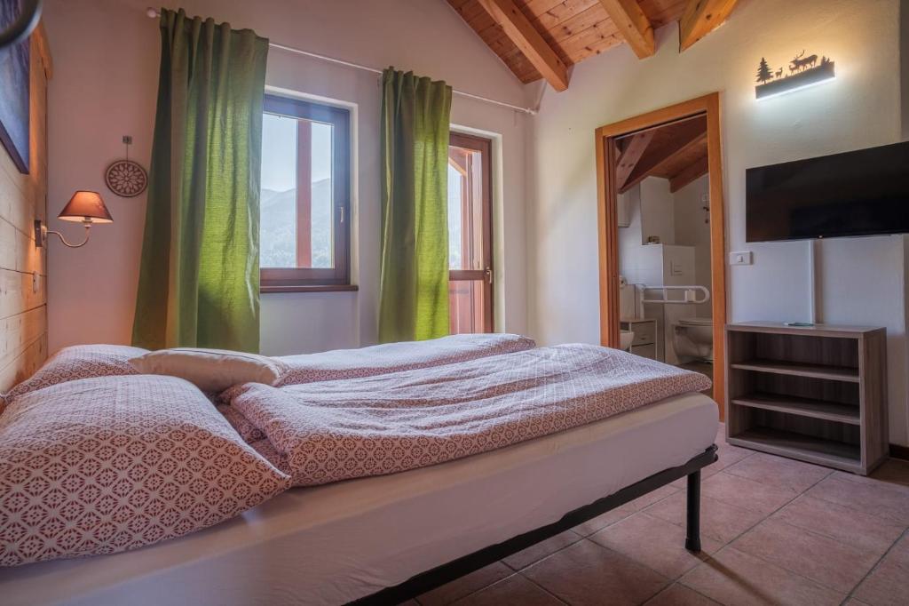 Postel nebo postele na pokoji v ubytování APARTHOTEL STREMBO