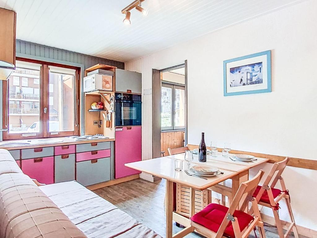 a kitchen with a table and a pink refrigerator at Apartment Les Chaudes Almes by Interhome in Tignes