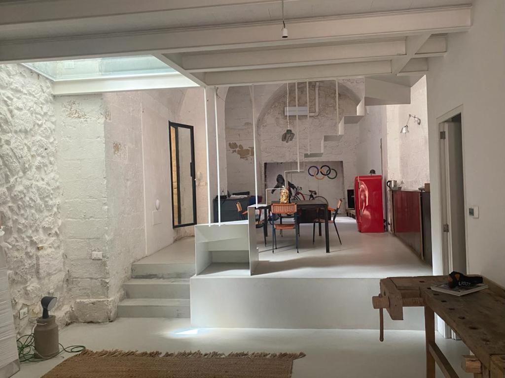 a living room with a table and a dining room at beccherie vecchie fancy loft in Lecce