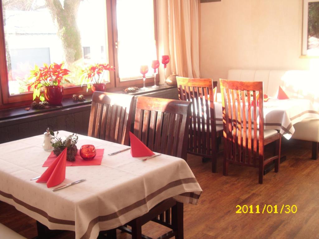 a dining room with a table and chairs with red napkins at Landhotel Pingel in Sundern
