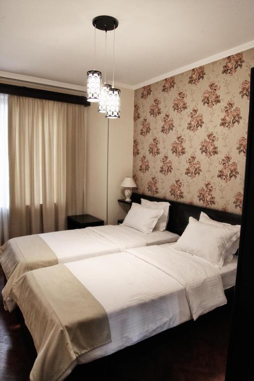 Postel nebo postele na pokoji v ubytování Hotel Four Brothers