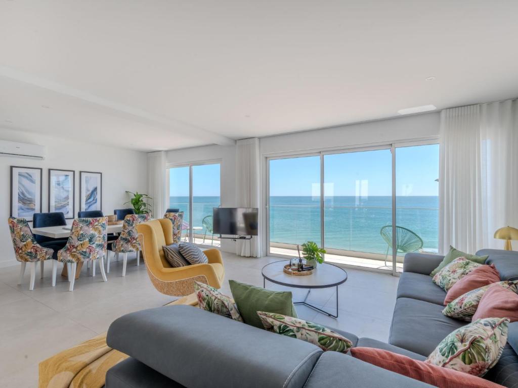 a living room with a view of the ocean at Holiday Home NANOUSH by Interhome in Albufeira
