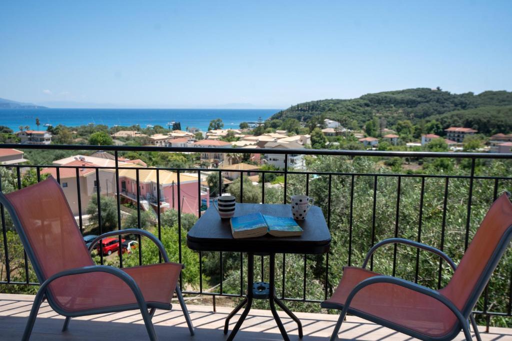 a table and chairs on a balcony with a view at Meltemi in Parga