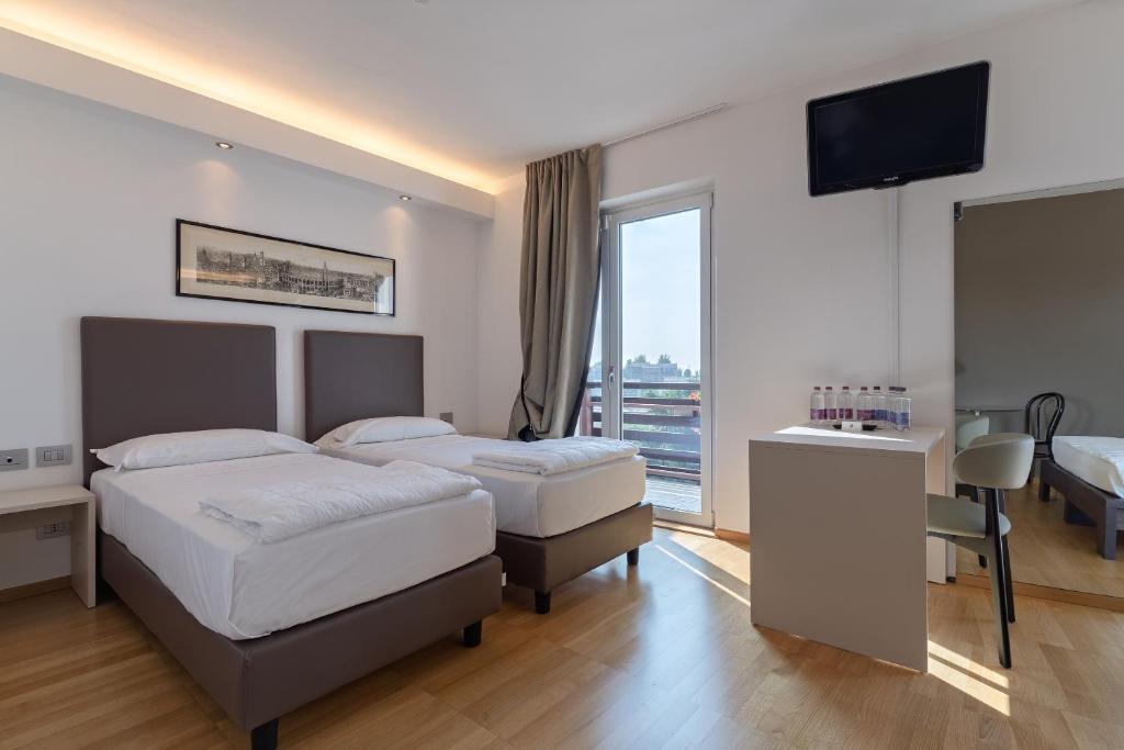 Postel nebo postele na pokoji v ubytování Hotel Pineta
