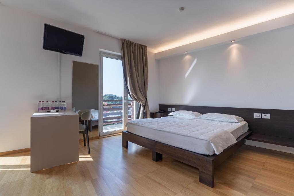 Postel nebo postele na pokoji v ubytování Hotel Pineta