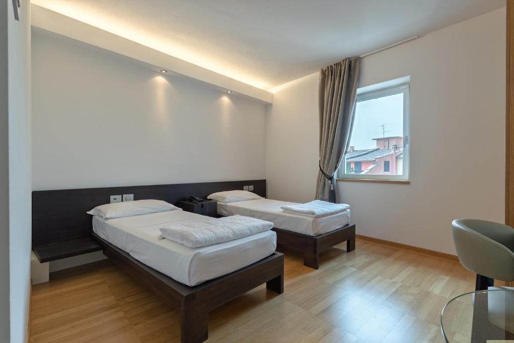 Postel nebo postele na pokoji v ubytování Hotel Pineta