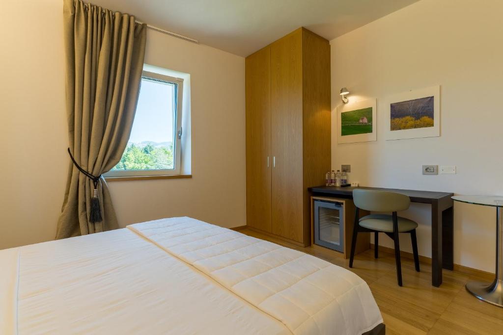 Postel nebo postele na pokoji v ubytování Hotel Pineta