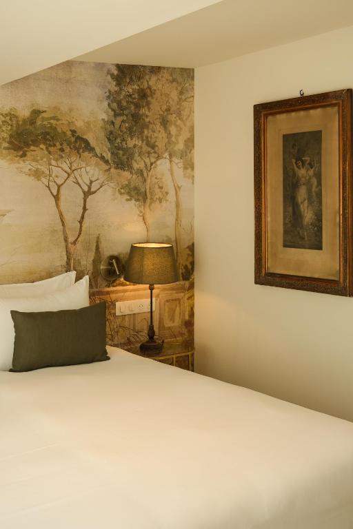 Postel nebo postele na pokoji v ubytování L'Abbaye Hôtel