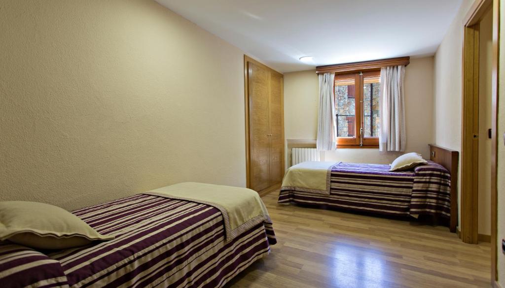 Postel nebo postele na pokoji v ubytování Hotel La Coma