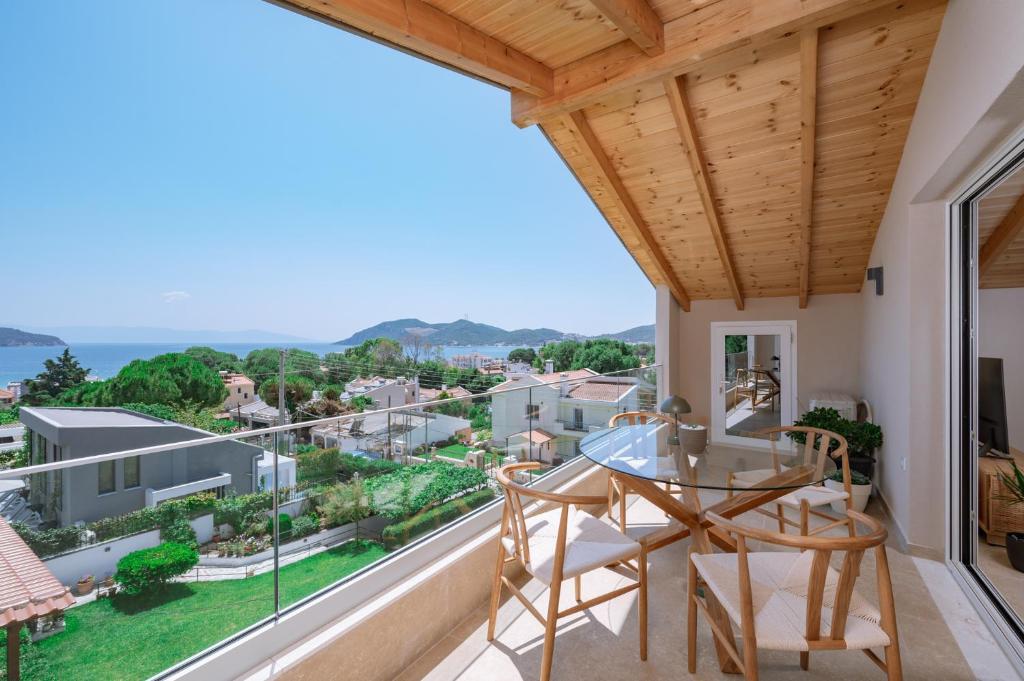 a view from the balcony of a house with a table and chairs at Goddess Thea Sea Apartment! in Iraklitsa