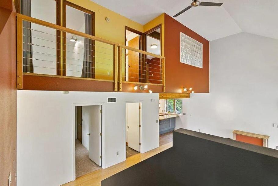 a living room with a staircase in a house at Zoo Town House with Sauna in Missoula