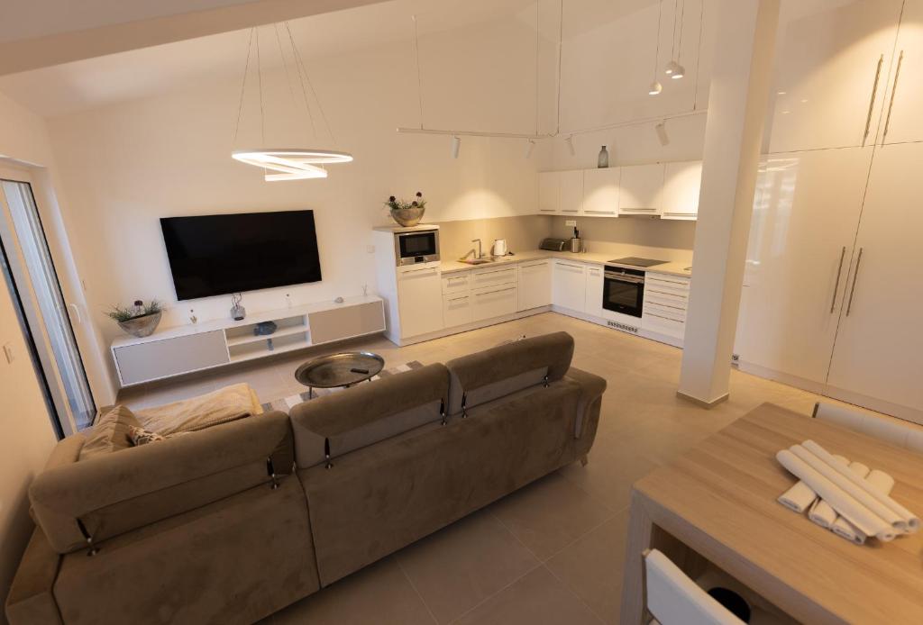 un ampio soggiorno con divano e TV di Apartment JARO a Stomorska