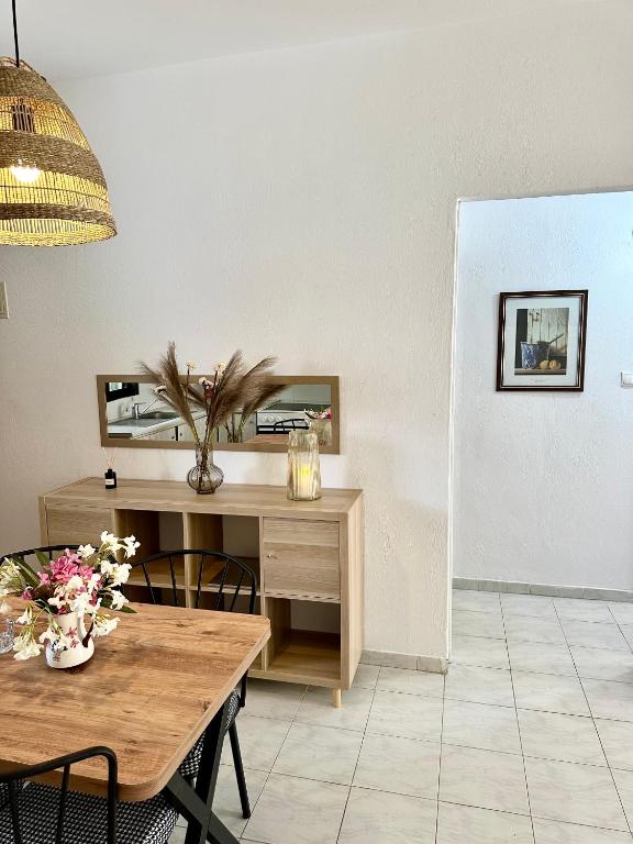 a dining room with a wooden table and a table and chairs at Sea La Vie - Premium in Polychrono