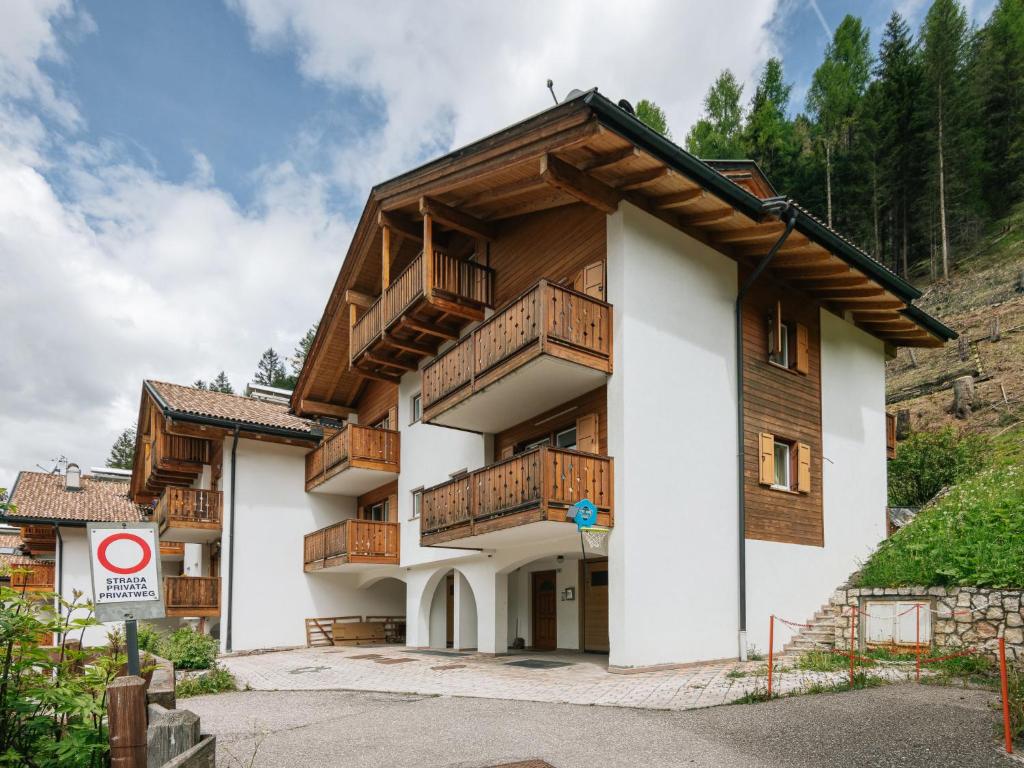 a building with wooden balconies on the side of it at Apartment Erika by Interhome in Canazei