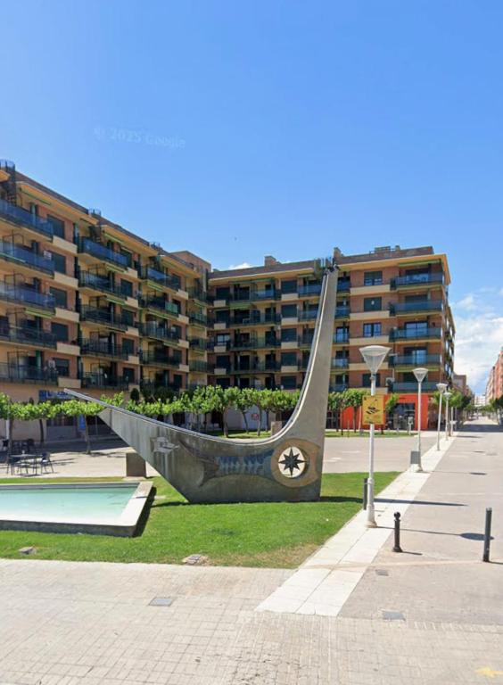 a sculpture of a boat in front of a building at Apartamento SOLCAPRI in Benicarló