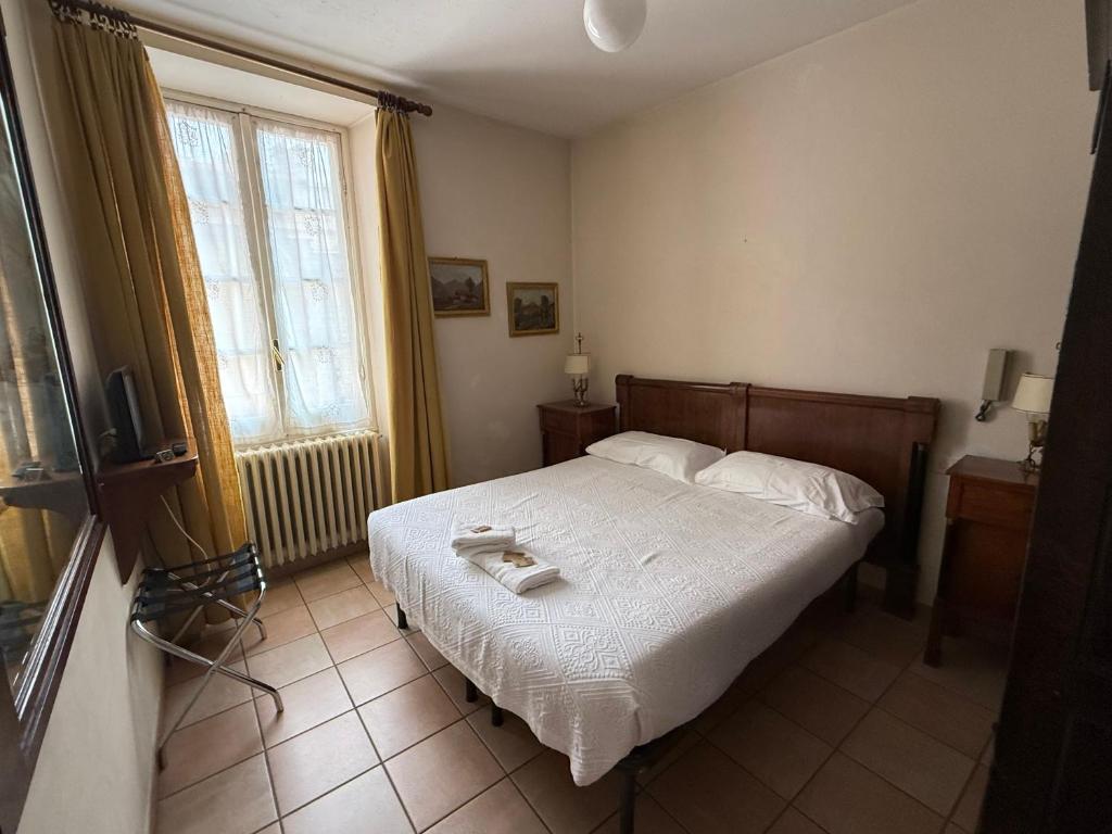 Postel nebo postele na pokoji v ubytování Albergo Dellangelo