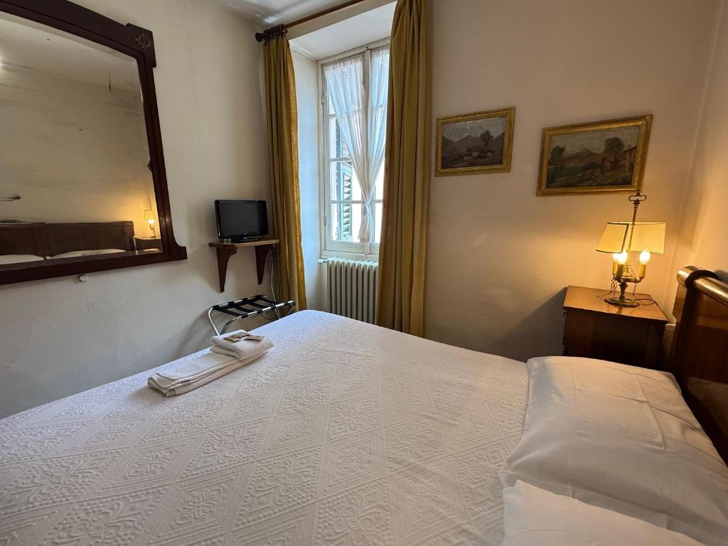 Postel nebo postele na pokoji v ubytování Albergo Dellangelo