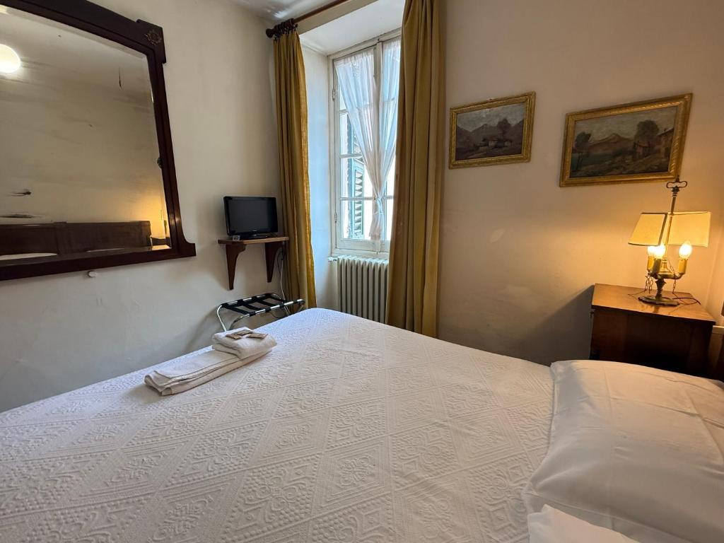 Postel nebo postele na pokoji v ubytování Albergo Dellangelo