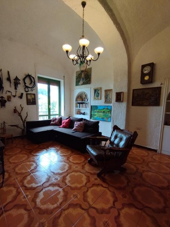 a living room with a couch and a chair at Casa Sole Luna in Torre del Greco