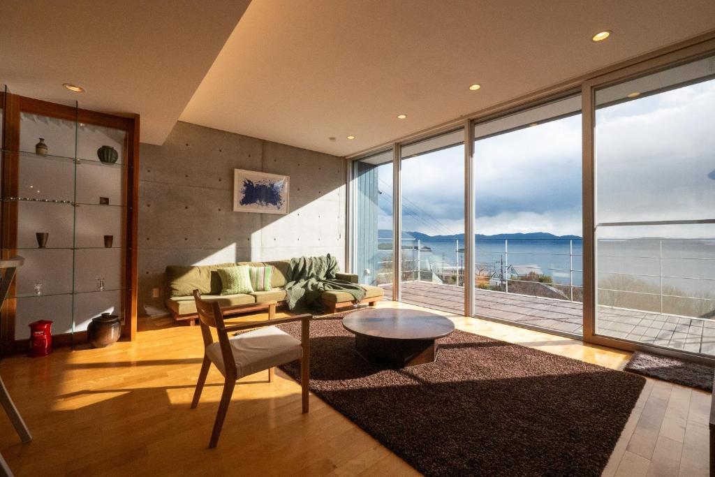 a living room with a couch and a table at USHIMADO Villa - Vacation STAY 61741v in Setouchi