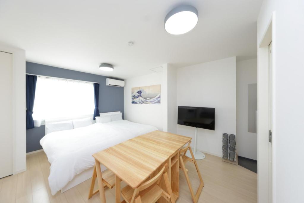 a bedroom with a bed and a wooden table at Rana Enoshima - Vacation STAY 94777v in Fujisawa
