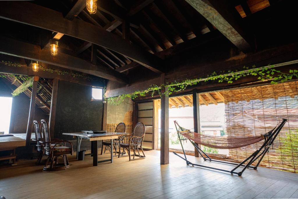 a hammock in a room with a table and chairs at Minamikoma-gun - House - Vacation STAY 19040 in Kajikazawa