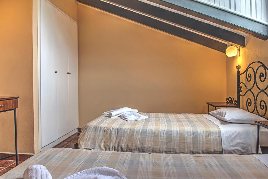 Postel nebo postele na pokoji v ubytování Legends Hotel Sidari Corfu