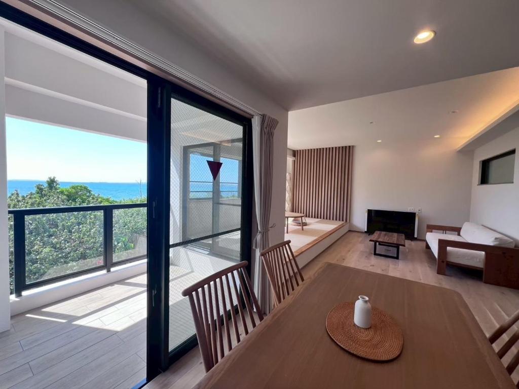 a living room with a table and a large window at LAGUNA OKINAWA Beachfront - Vacation STAY 30553v in Yaka