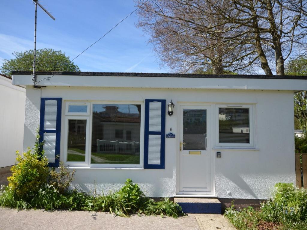 a small white house with blue shutters at 2 Bed in Brixham BX081 in Brixham